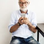 senior man looking at mobile