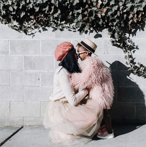 Destiney and her daughter on a sidewalk
